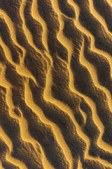Closeup on the sand dunes. Footprints in the sand.
