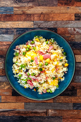 Homemade Chinese fried rice with vegetables and fried eggs