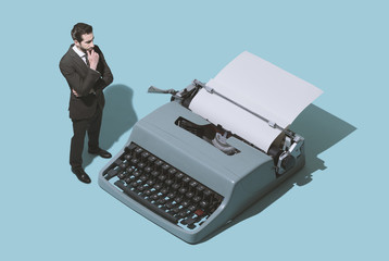 Man waiting for new ideas next to a typewriter