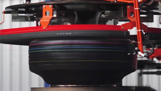 Tire Curing Molds. Tire production machine close up. Modern automated tyre forming tyres machine. Production process of tyres on modern equipment in the factory. Robotic machine in a tire factory.