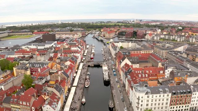 Aerial view of Nyhavn at sunrise, with colorful facades of old houses and old ships in the Old Town of Copenhagen, capital of Denmark.