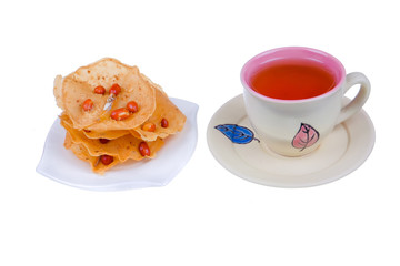 Tea cup and rempeyek on white background