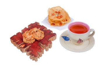 Tea cup , rempeyek and honey corn flake cookies  on white background