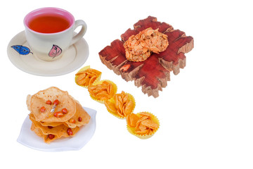 Tea cup , florentine , honey corn flake cookies and rempeyek on white background