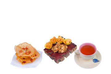 Tea cup , rempeyek and honey corn flake cookies  on white background