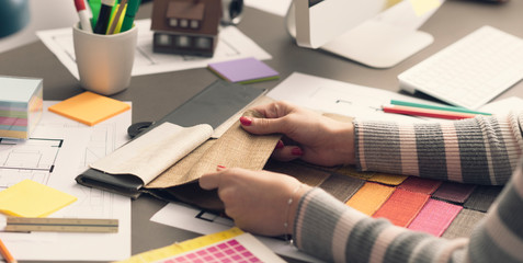 Professional decorator choosing fabric swatches