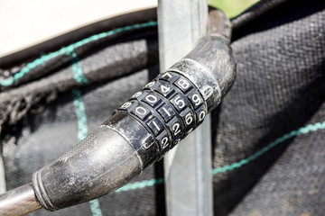 chain and padlock with number combination on blackboard.