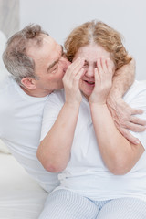 an elderly husband calms a crying wife