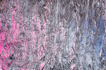 Abstract crumpled foil background. Grunge photo background. Pink and blue shadows