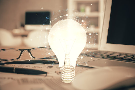 Bulb drawing with glasses on the table background. Idea concept. Double exposure.