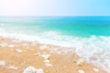 Fototapeta na wymiar Blurred sea background. Beautiful beach with turquoise water. Travel and vacation concept