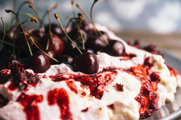 Cherry dessert with whipped cream and meringue cream. Selective focus. Shallow depth of field.