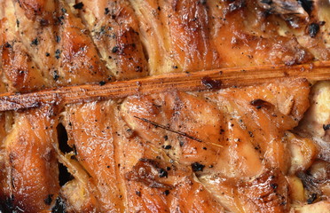 roasted chicken in wooden stick on white background