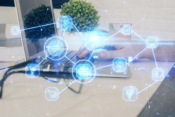 Social network theme hologram with businessman working on computer on background. Multi exposure.