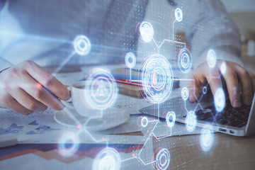 Double exposure of data internet theme hologram with man working on computer on background. Concept of innovation.