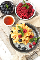 Homemade pancakes with fresh berry and honey.Healthy summer breakfast