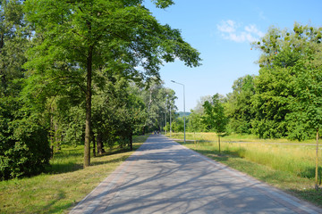 A long, wide road and Park on the nature.
