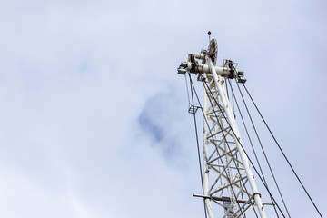 detail of a crane located on the dock of the port awaiting loading .