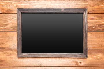 Blank chalkboard on brown wooden background