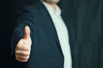 Businessman shows thumb or thumbs up