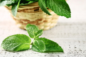 Mint leafs on white wooden table