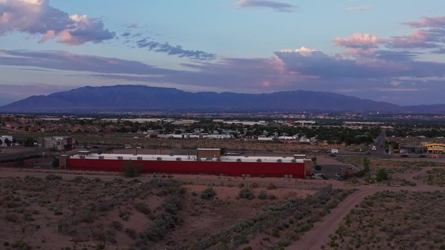 Flying over the desert towards the picturesque town of Albuquerque New Mexico - Drone Aerial Shot