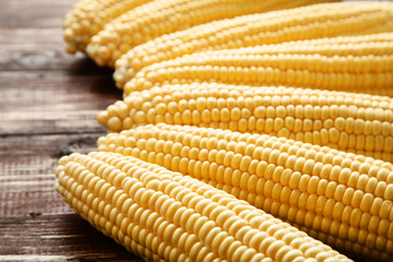 Ripe corn on brown wooden table