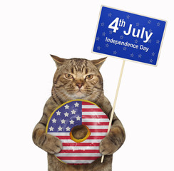 The cat patriot is holding a big american donut and a poster -  4th July Independence Day. White background. Isolated.