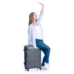 Woman with travel suitcase standing smiling on white background isolation