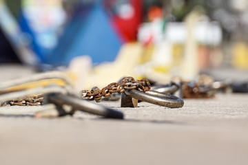 Nautical anchor chain with rust in the pier.