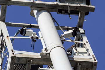 high tower of CCTV camera system in daytime