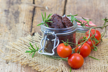 fresh and dried tomatoes on wooden background