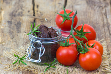 fresh and dried tomatoes on wooden background