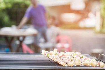  Friends making barbecue and having dinner at the nature background.