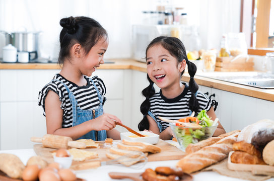 kids happy and fun preparing make the Sandwiches and salads at a kitchen