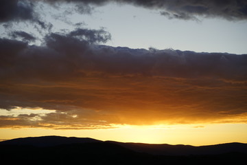 Brilliant Sunset with Clouds Over Mountains