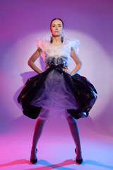 Girl posing in a dress made of plastic film. Fashion portrait.