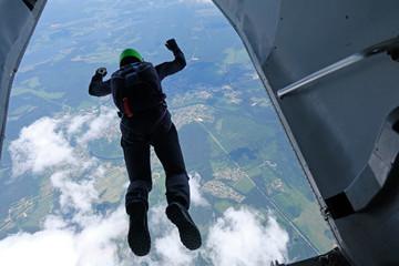 SKydiving. A skydiver is jumping out of a plane. 