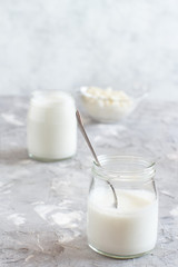 Fermented drink kefir in small bottles and kefir grains