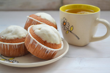 Closeup of lemon cupcakes with  cup of tea