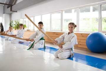 Girl sitting near her friends while training together