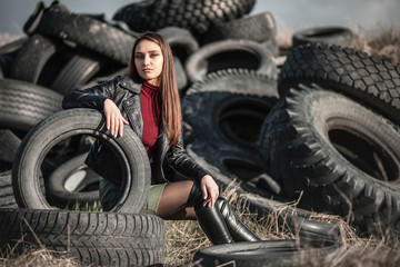 Obraz na płótnie Canvas Girl sitting in the tyres