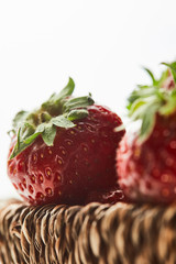 delicious sweet strawberries in wicker basket isolated on white