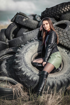Girl sitting in the tyres