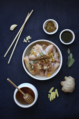Chiken wings marinated with ginger, mustard, soya sauce and honey. Asian food. Top view.
