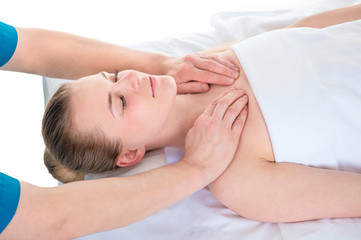 Young woman's shoulder joints being manipulated by an osteopath - an alternative medicine treatment
