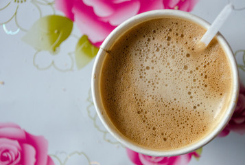 cup of coffee with flowers on red background