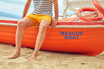 Rescue boat and lifeguard keeping the beach safe in summertime period.