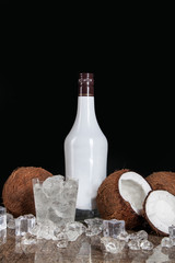 coconut with ice cubes on a black background