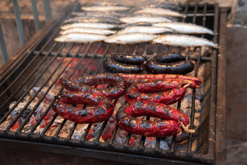 sausages and sardines in a grill